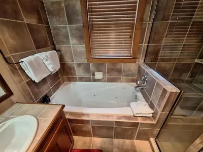 a bathroom with a tub and a sink at 3BR Red Hawk Townhome - Gondola Access townhouse in Keystone