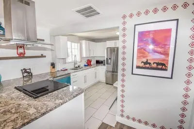 a kitchen with a painting of horses on the wall at Charming Cowboy Bunkhouse in Denver in Denver