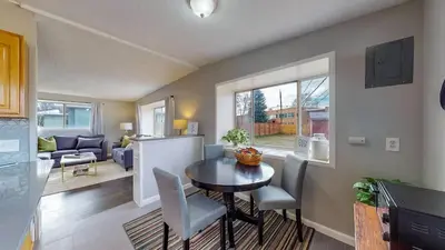 a kitchen and living room with a table and chairs at Charming Three Bedroom Home in Littleton in Littleton
