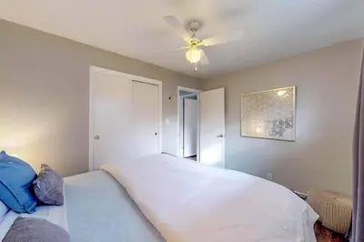 a bedroom with a white bed and a ceiling fan at Charming Three Bedroom Home in Littleton in Littleton