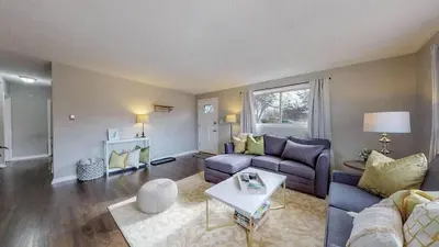 a living room with a couch and a table at Charming Three Bedroom Home in Littleton in Littleton