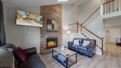 a living room with a couch and a fireplace at Comfortable Family Friendly Home on Quincy Reservoir in Aurora