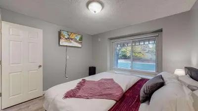 a bedroom with a white bed and a window at Comfortable Family Friendly Home on Quincy Reservoir in Aurora