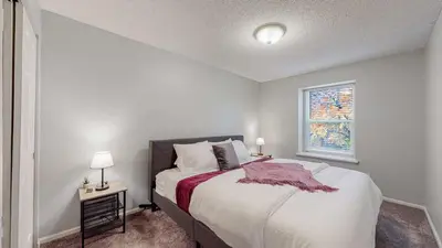 a bedroom with a large bed and a window at Comfortable Family Friendly Home on Quincy Reservoir in Aurora