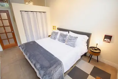 a bedroom with a large white bed and a window at Trendy Modern Loft in Rino Art District in Denver