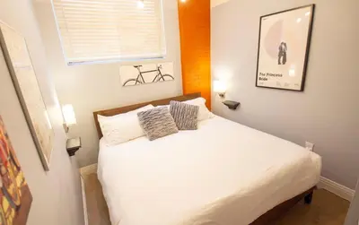 a bedroom with a white bed with two pillows on it at Trendy Modern Loft in Rino Art District in Denver