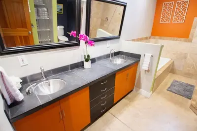 a bathroom with two sinks and a vase of flowers at Trendy Modern Loft in Rino Art District in Denver