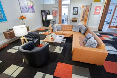 a living room with a couch and two chairs at Trendy Modern Loft in Rino Art District in Denver