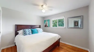 a bedroom with a bed with a ceiling fan at Charming four bedroom home with large yard and plenty of room for family in Centennial