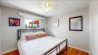 a bedroom with a bed and a ceiling fan at Charming four bedroom home with large yard and plenty of room for family in Centennial