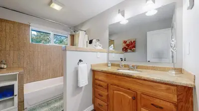 a bathroom with a sink and a bath tub at Charming four bedroom home with large yard and plenty of room for family in Centennial
