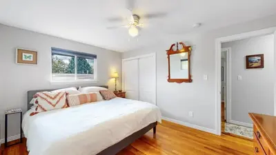 a bedroom with a white bed and a window at Charming four bedroom home with large yard and plenty of room for family in Centennial