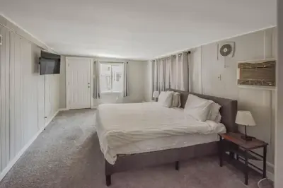 a bedroom with a large bed with white sheets and pillows at Spacious ranch on large lot near water world in Federal Heights
