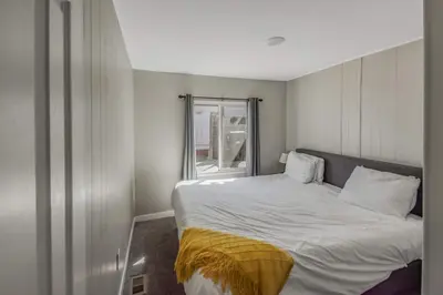 a small bedroom with a bed and a window at Spacious ranch on large lot near water world in Federal Heights