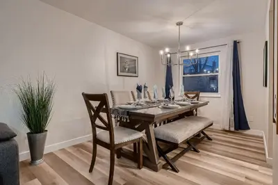 a dining room with a wooden table and chairs at The Arvada Retreat with HotTub, Games, Gym and Lounge in Arvada