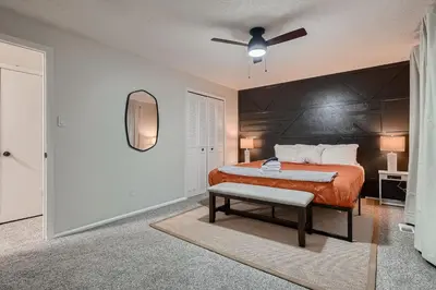 a bedroom with a bed and a ceiling fan at The Arvada Retreat with HotTub, Games, Gym and Lounge in Arvada