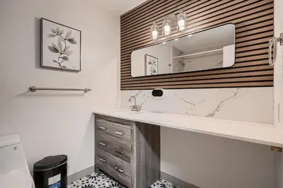 a bathroom with a sink and a mirror at The Arvada Retreat with HotTub, Games, Gym and Lounge in Arvada
