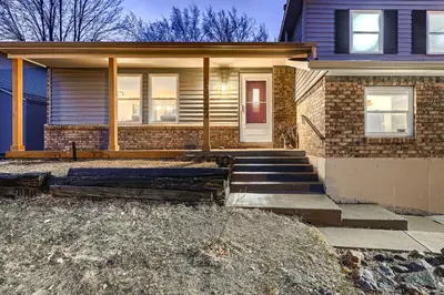 a house with a front porch and stairs in front at The Arvada Retreat with HotTub, Games, Gym and Lounge in Arvada