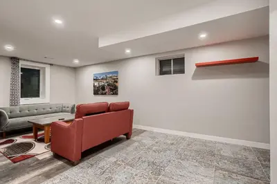 a living room with a couch and a table at The Arvada Retreat with HotTub, Games, Gym and Lounge in Arvada