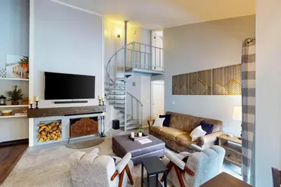 a living room with a couch and a fireplace at Flying Dutchman - Snow Owl Condo in Keystone
