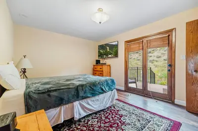a bedroom with a bed and a sliding glass door at Spacious Keystone Family Escape Great Location in Keystone