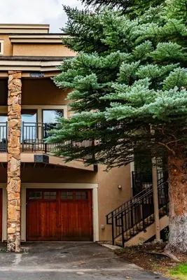 a house with a pine tree in front of it at Spacious Keystone Family Escape Great Location in Keystone