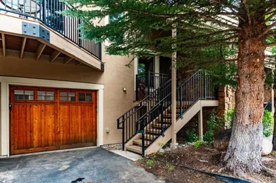 a house with a wooden door and a tree at Spacious Keystone Family Escape Great Location in Keystone