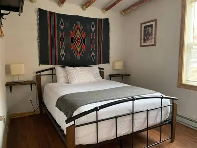 a bedroom with a bed with a large head board at Native Spirit Cabin at Base Camp in Dumont