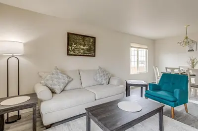 a living room with a couch and a blue chair at 5 Mi to Cherry Creek State Park Cozy Family Home! in Aurora