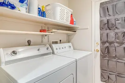 a laundry room with a washer and dryer at 5 Mi to Cherry Creek State Park Cozy Family Home! in Aurora