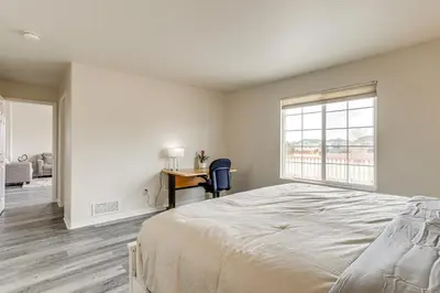 a bedroom with a bed and a desk and a window at 5 Mi to Cherry Creek State Park Cozy Family Home! in Aurora