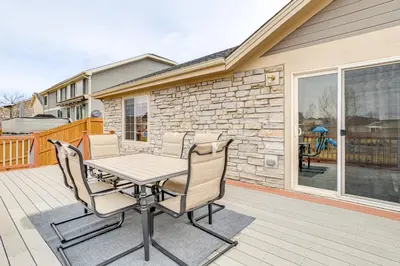 a patio with a table and chairs on a deck at 5 Mi to Cherry Creek State Park Cozy Family Home! in Aurora