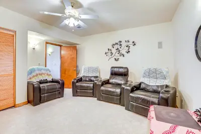 a living room with leather chairs and a ceiling fan at 7 Mi to Dtwn Denver Lakefront Gem with Dock! in Denver