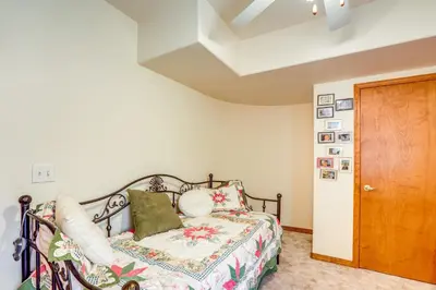 a bedroom with a bed and a wooden door at 7 Mi to Dtwn Denver Lakefront Gem with Dock! in Denver