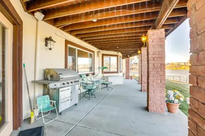 an outdoor patio with a grill and tables and chairs at 7 Mi to Dtwn Denver Lakefront Gem with Dock! in Denver