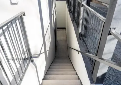 a stairway in a building with metal railings at Bright retreat near Tennyson w full kitchen in Denver