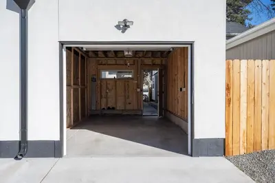 a hallway leading to a garage with wooden doors at Bright retreat near Tennyson w full kitchen in Denver