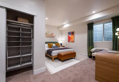 a bedroom with a bed and a closet at Bright retreat near Tennyson w full kitchen in Denver