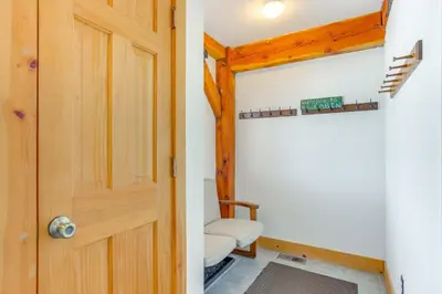 a door leading into a room with a chair at 6 Mi to Winter Park Resort Spacious Family Cabin in Fraser
