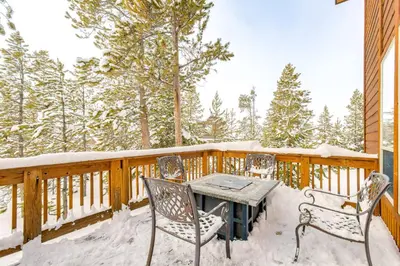 a table and chairs on a deck covered in snow at 6 Mi to Winter Park Resort Spacious Family Cabin in Fraser