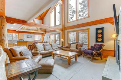 a living room with couches and a table at 6 Mi to Winter Park Resort Spacious Family Cabin in Fraser