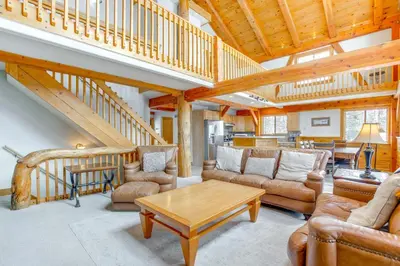 a living room with couches and a wooden staircase at 6 Mi to Winter Park Resort Spacious Family Cabin in Fraser
