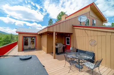 a patio with a table and chairs on a deck at Golden Oasis in Golden