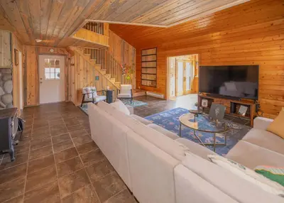 a living room with a couch and a flat screen tv at Golden Oasis in Golden