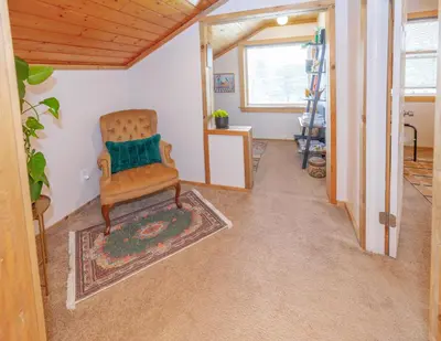 a living room with a chair and a ladder at Golden Oasis in Golden