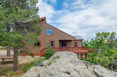 a barn house with a large rock in front of it at Golden Oasis in Golden