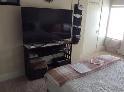 a living room with a large flat screen tv at Charming Studio Apartment in the Heart of Golden in Golden