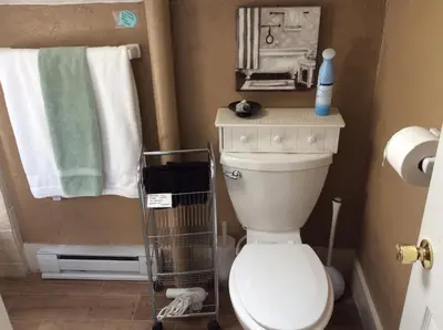 a small bathroom with a toilet and towels at Charming Studio Apartment in the Heart of Golden in Golden