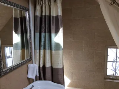 a bathroom with a sink and a mirror at Charming Studio Apartment in the Heart of Golden in Golden