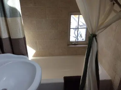 a bathroom with a sink and a window at Charming Studio Apartment in the Heart of Golden in Golden